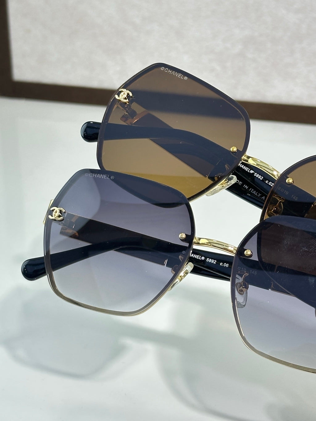 Chanel glasses close-up with navy lenses and gold-trimmed frames