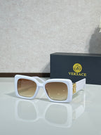 Square Versace sunglasses, white frame with beige-tinted lenses.