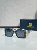 Square Versace sunglasses, teal-blue frame with dark gray lenses.