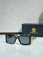 Square Versace sunglasses, black frame with teal-tinted lenses.