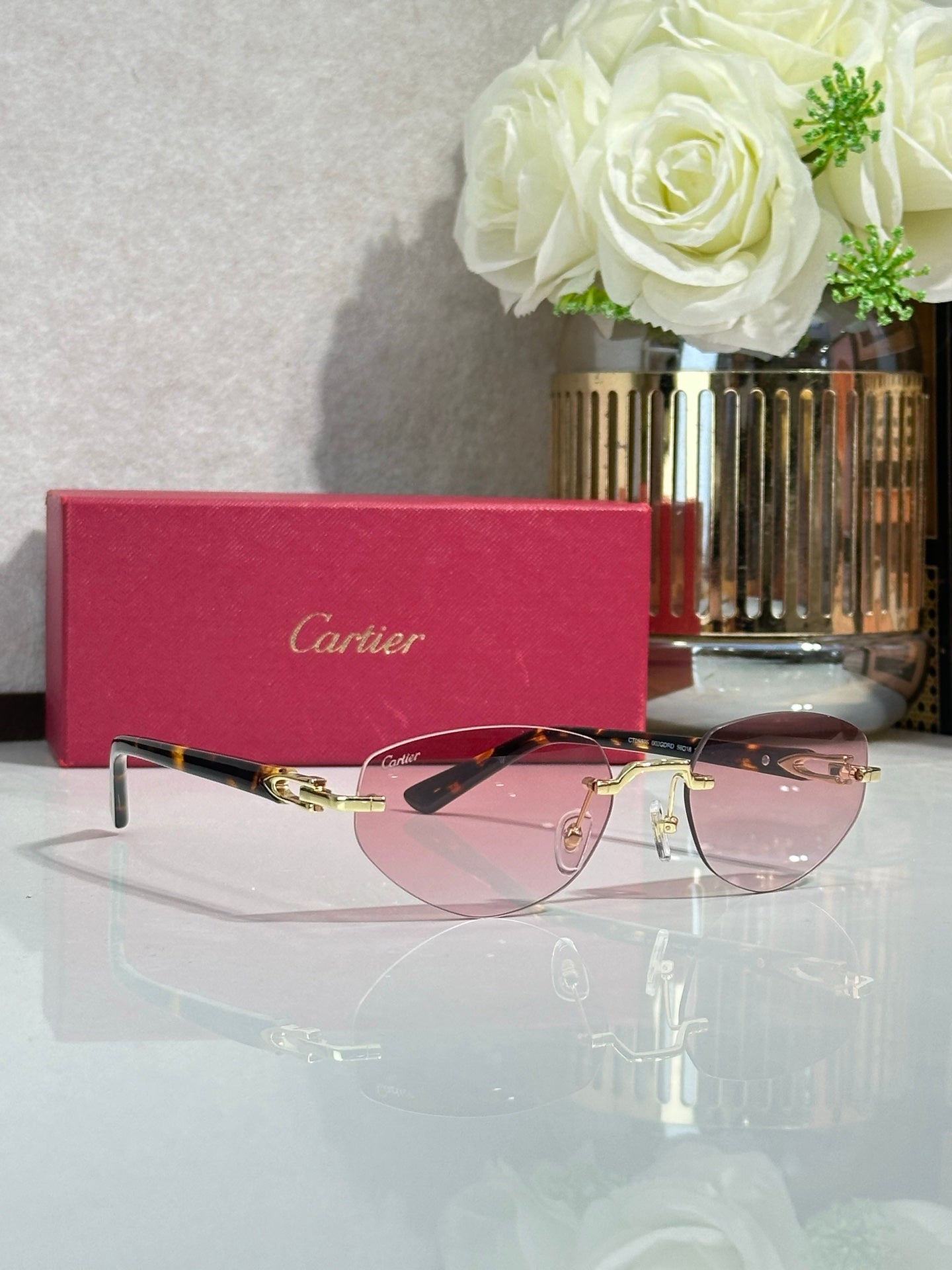 Cartier sunglasses side view with pink lenses and gold-tone frame