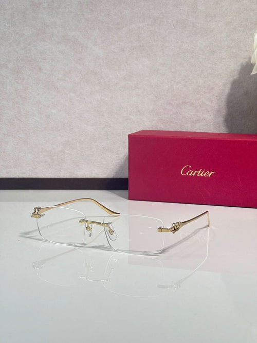 Eyeglasses with clear frame and gold-tone metal temples, wire-style construction