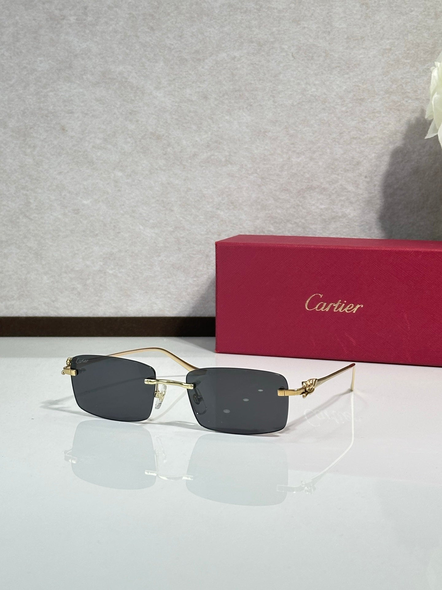 Sunglasses with dark lenses and black front, gold-tone temple hardware