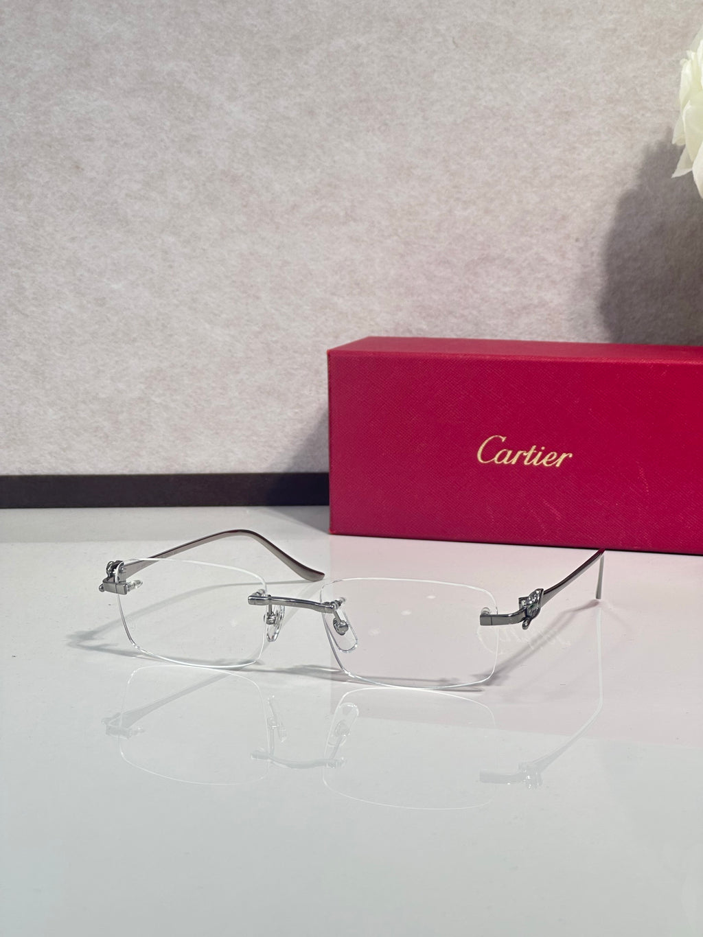 Eyeglasses with clear frame and gold-tone metal temples, side profile with lens bridge