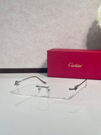 Eyeglasses with clear frame and gold-tone metal temples, side profile with lens bridge