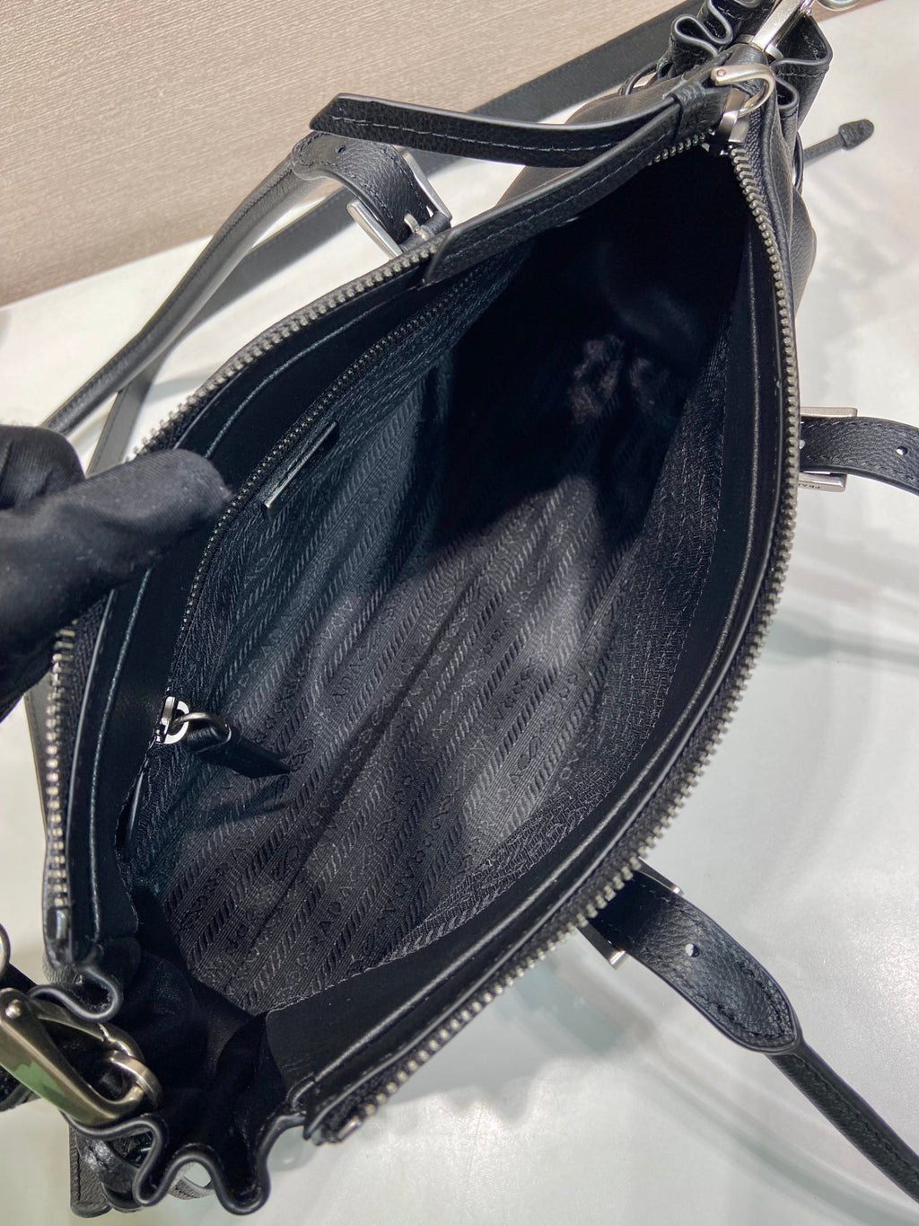 Prada bag interior with zip opening and jacquard lining in dark blue leather