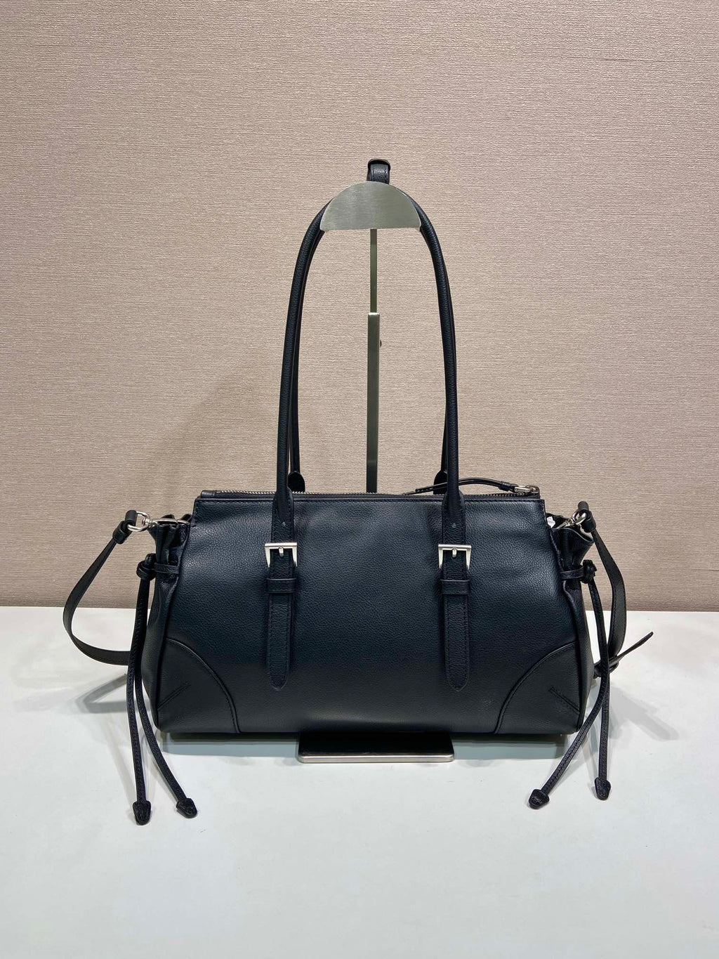 Prada handbag in dark blue leather, front view with dual straps and metal hardware