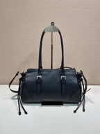 Prada handbag in dark blue leather, front view with dual straps and metal hardware