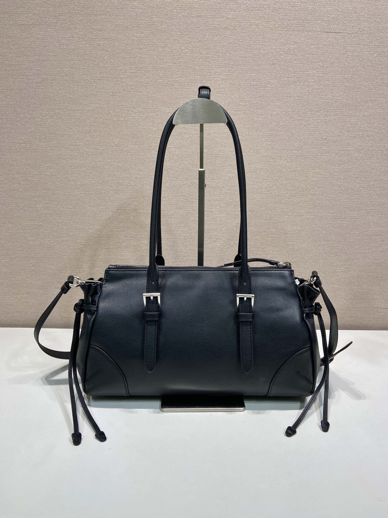 Prada handbag in dark blue leather, front view with dual straps and metal hardware