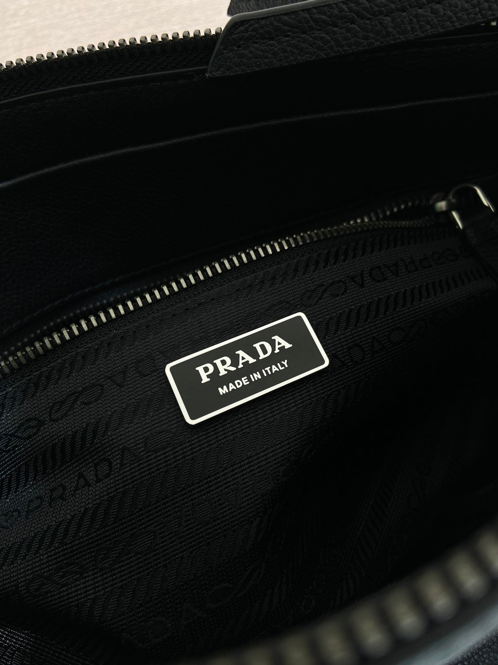 Prada bag interior label with logo patch inside zip pocket, dark blue