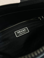 Prada bag interior label with logo patch inside zip pocket, dark blue