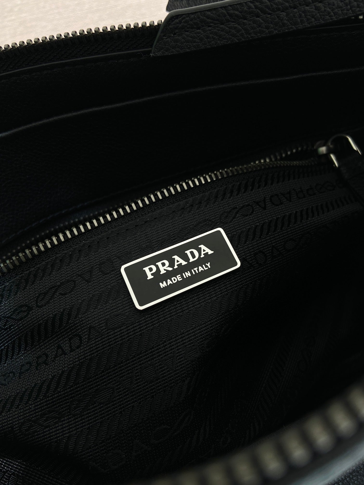 Prada bag interior label with logo patch inside zip pocket, dark blue