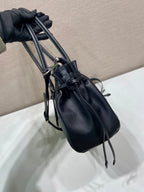Prada mini handbag in dark blue leather with adjustable crossbody strap and tassel ends