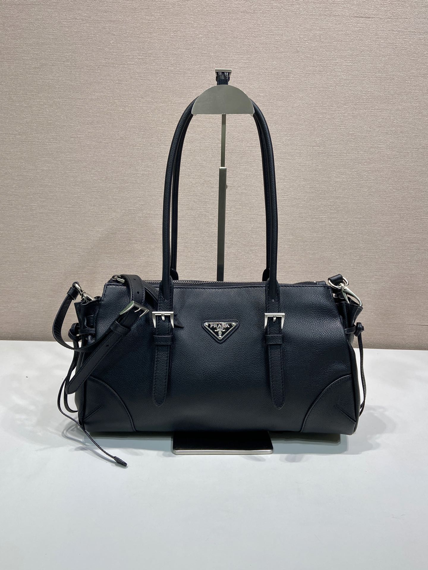 Prada handbag in dark blue leather, structured top handles with side straps