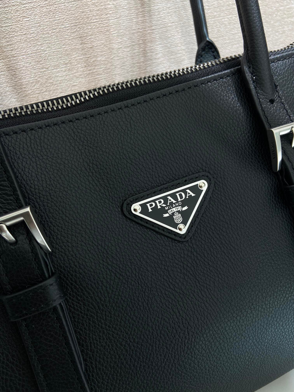 Prada bag in dark blue leather with embossed texture and metal triangular logo plate