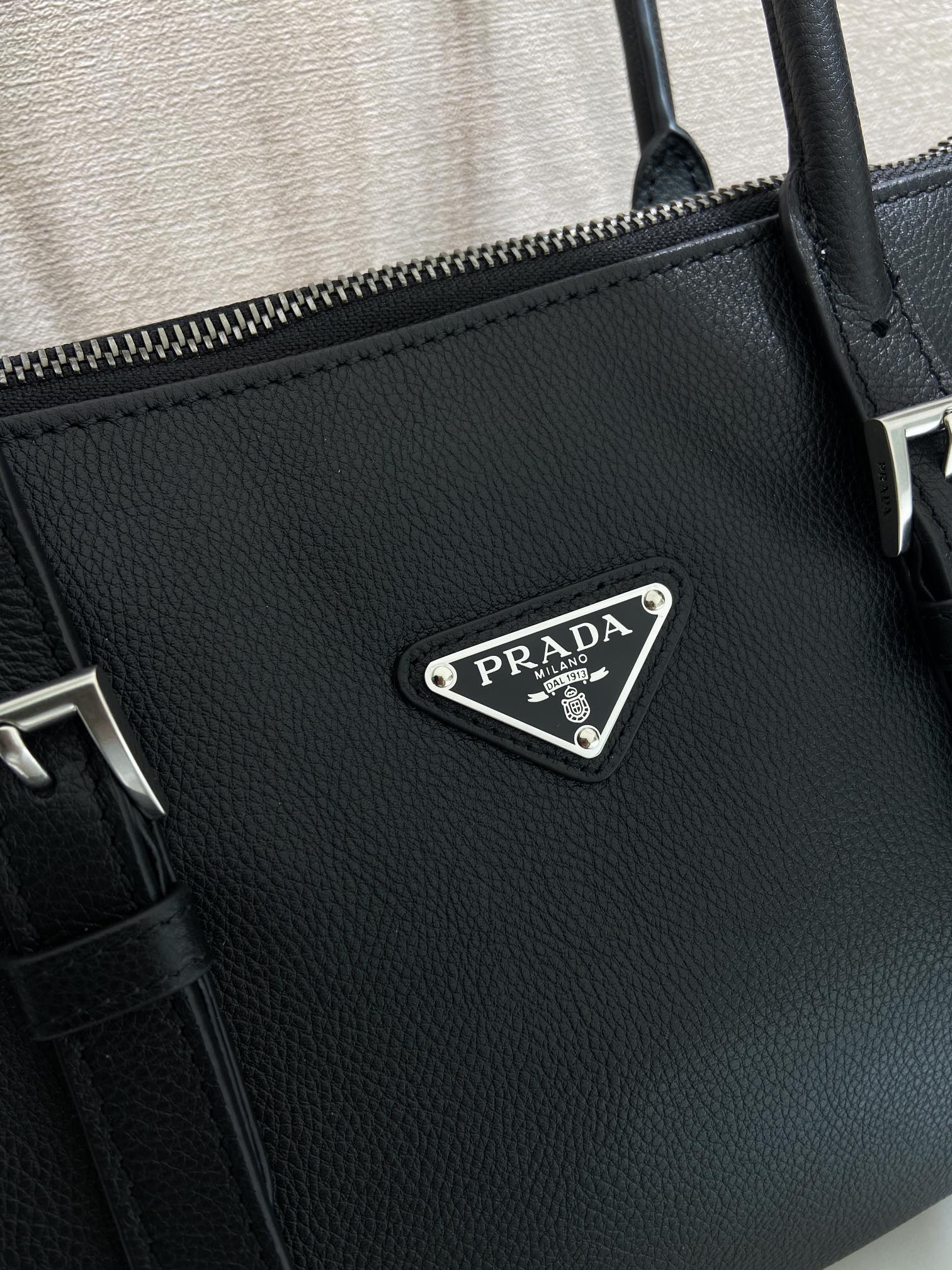 Prada bag in dark blue leather with embossed texture and metal triangular logo plate