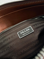 Prada logo label on brown monogram interior zip pocket, 'Made in Italy' tag