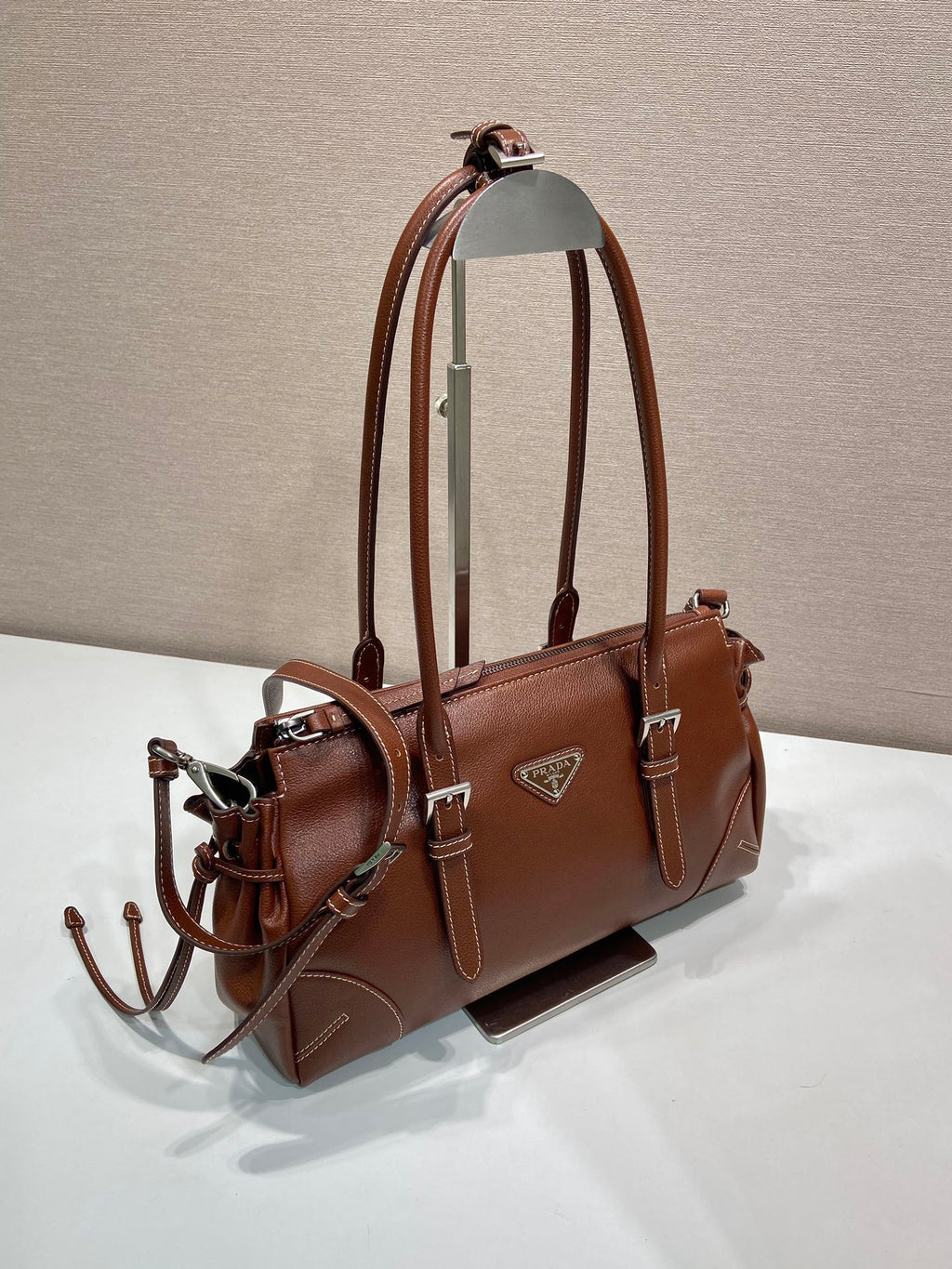 Prada brown leather tote bag, side view with detachable strap and silver hardware