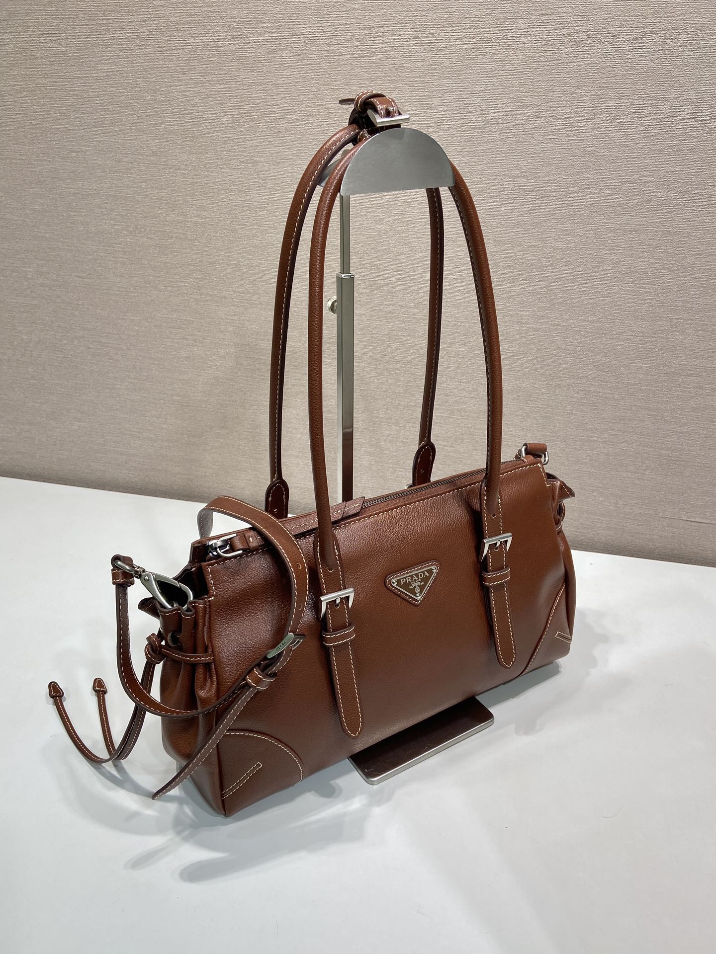 Prada brown leather tote bag, side view with detachable strap and silver hardware