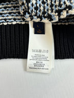 Size L care label on houndstooth sweater, washing instructions and materials tag