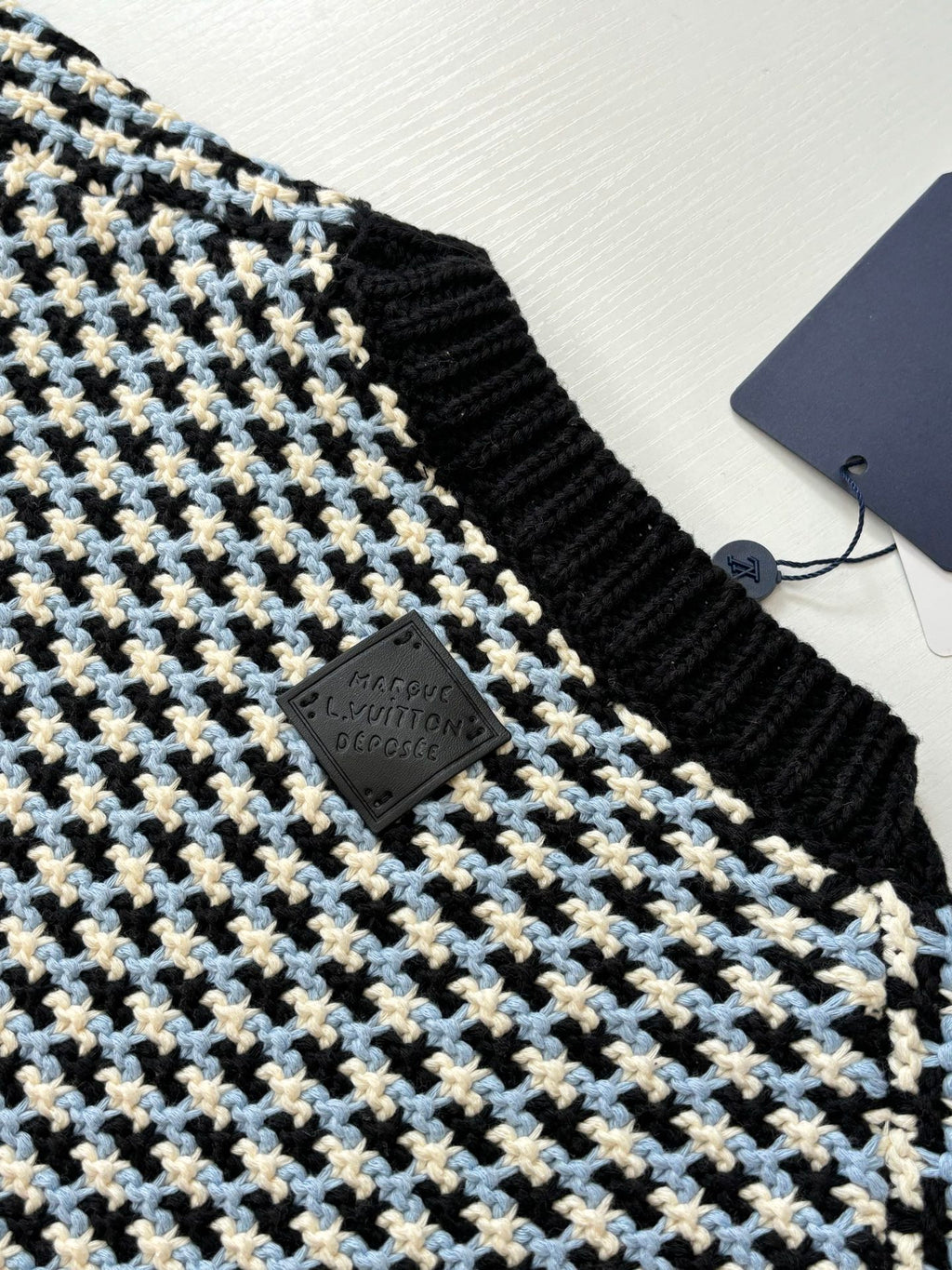 Houndstooth crewneck sweater neckline detail, black rib trim with Louis Vuitton logo tag