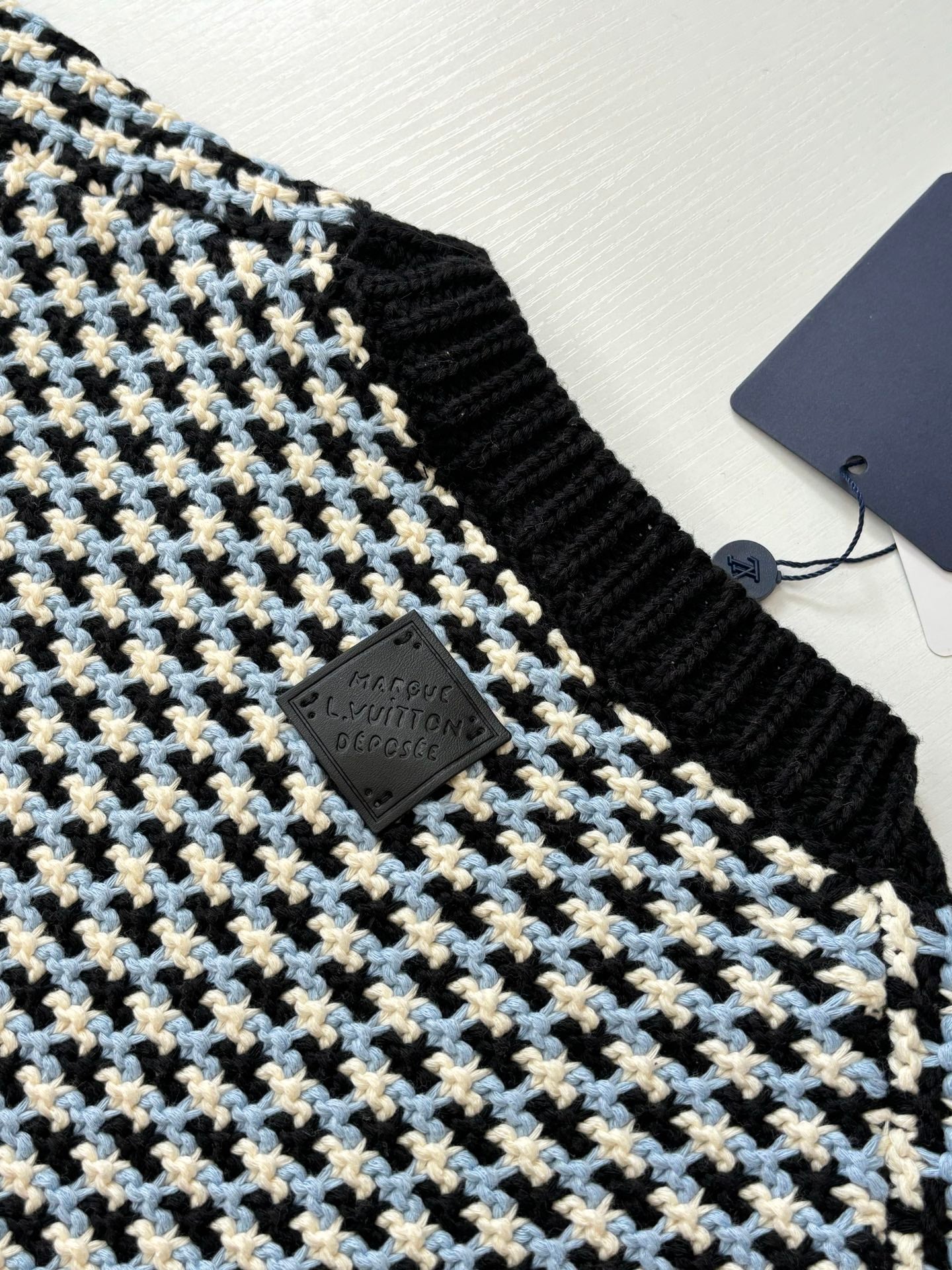 Houndstooth crewneck sweater neckline detail, black rib trim with Louis Vuitton logo tag