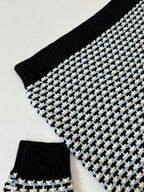 Houndstooth knit sleeve with black rib cuff, cream/blue grid pattern