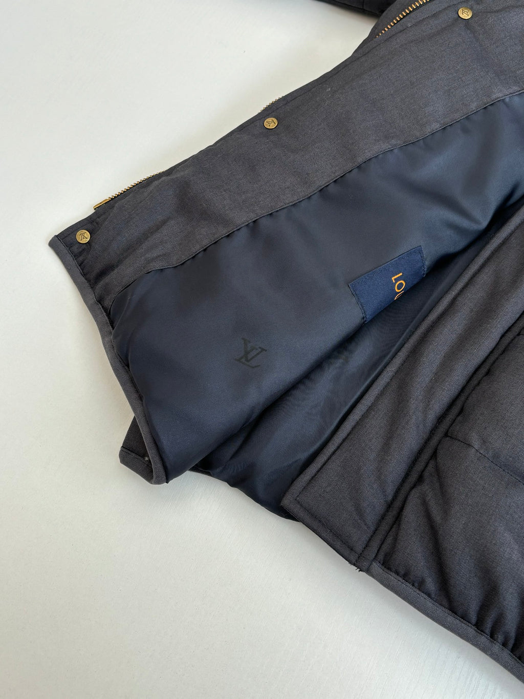 Dark navy puffer jacket hooded collar and front chest logo patch