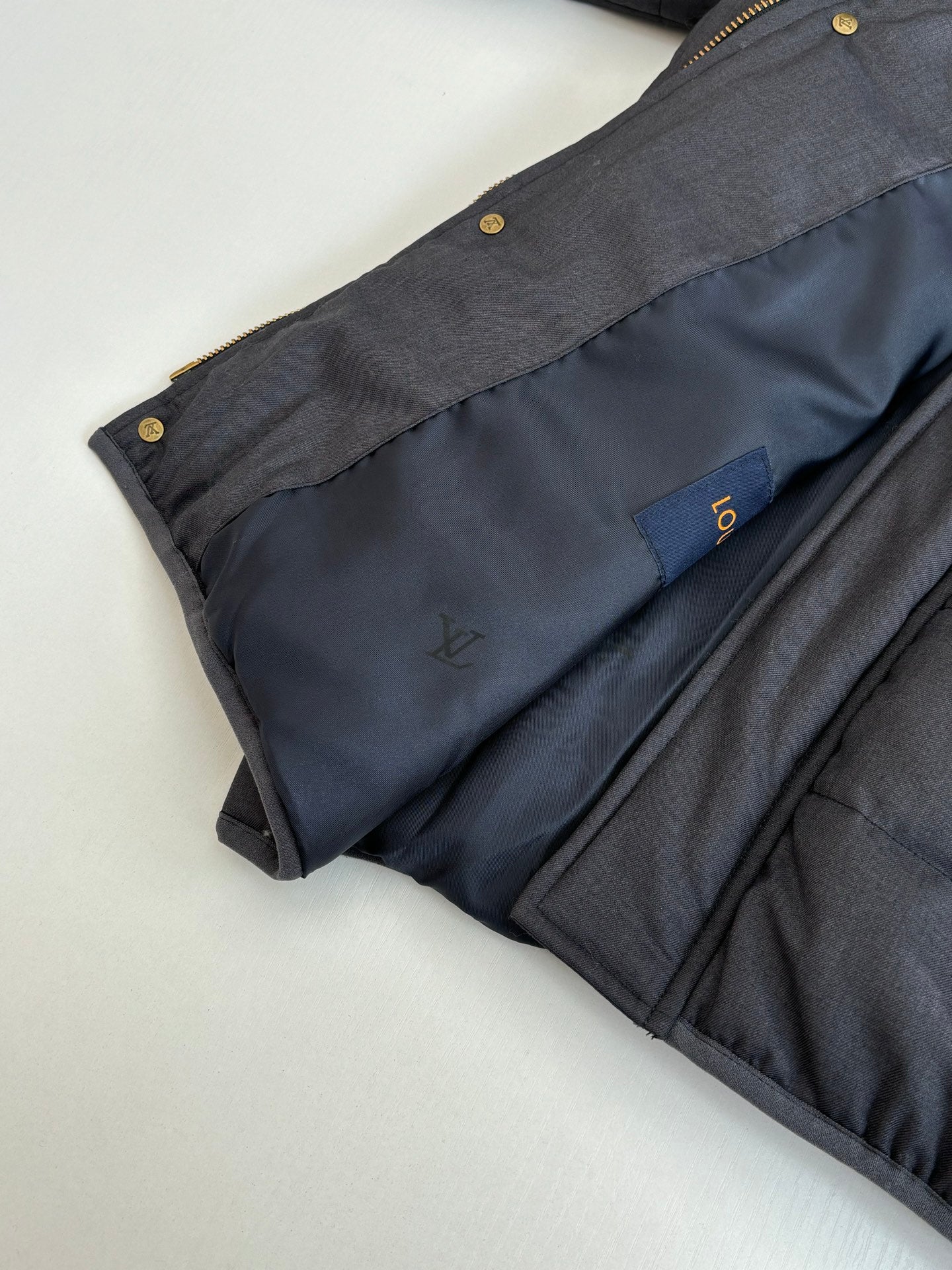 Dark navy puffer jacket hooded collar and front chest logo patch