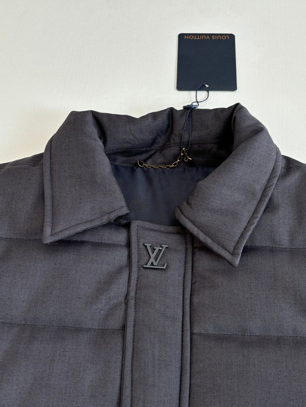 Dark navy puffer jacket with embroidered LV monogram on the front