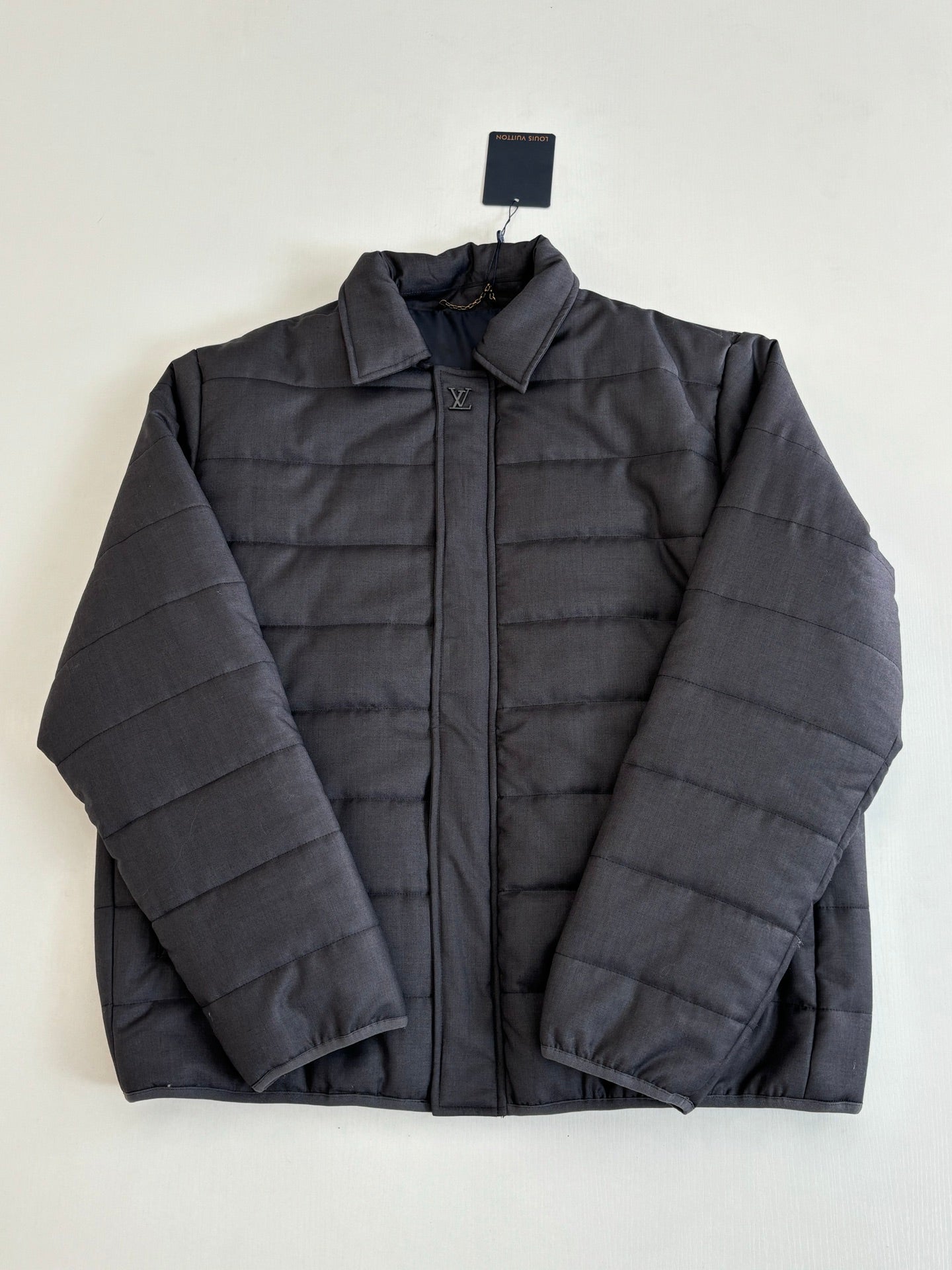 Dark navy long puffer jacket with stand collar and front zip