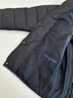 Dark navy puffer jacket sleeve with Louis Vuitton logo patch