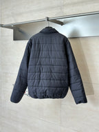 Dark navy long puffer jacket back view with quilted panels