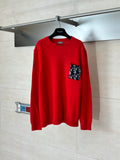Red knit long-sleeve sweater with ribbed hem and pocket with logo pattern patch