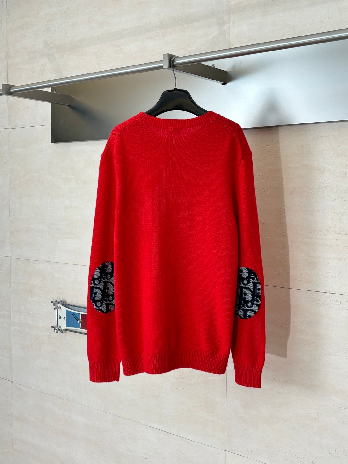 Red knit long-sleeve sweater, back view with ribbed hem and cuffs