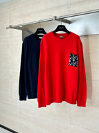 Red knit long-sleeve sweater on hanger with logo-pattern pocket and ribbed cuffs