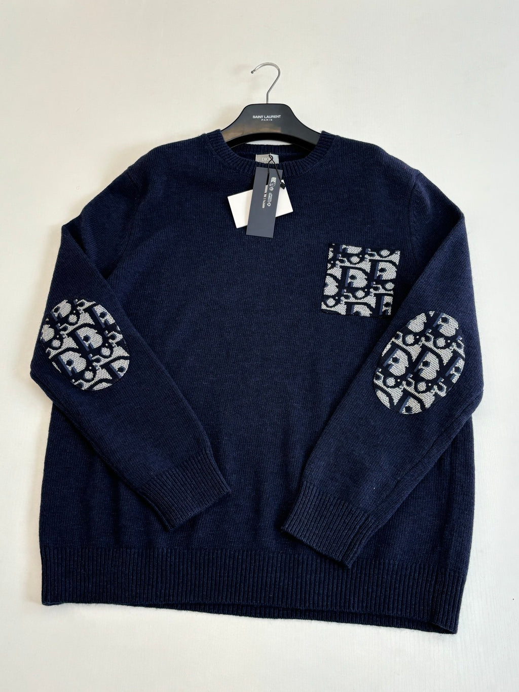 Navy knit sweater with logo graphic patch at chest and sleeves