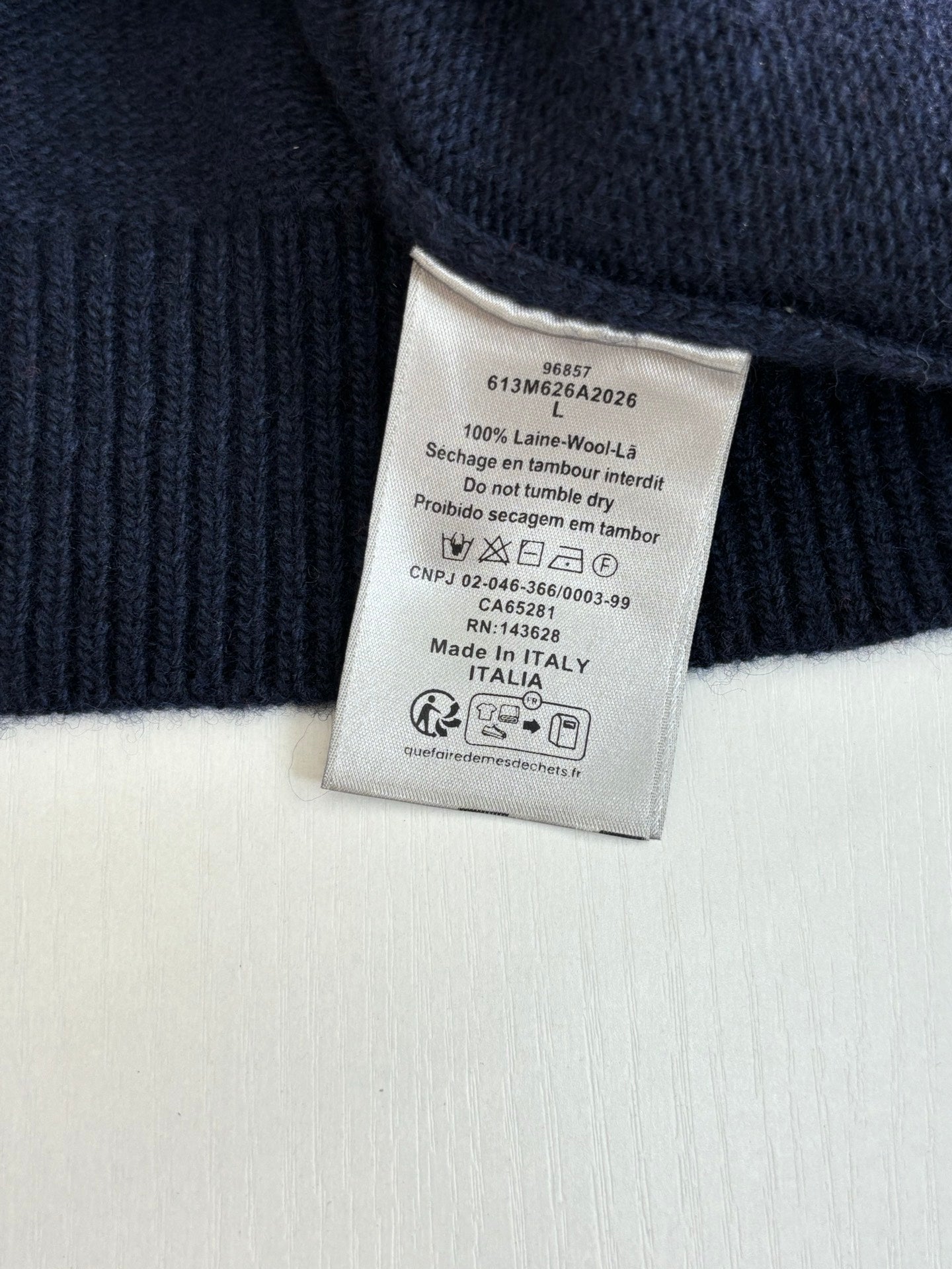 Inside neck label on navy knit sweater, Made in Italy tag
