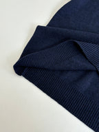 Navy ribbed knit sleeve cuff with folded hem detail