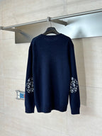 Navy long-sleeve knit sweater with logo graphic on both sleeves
