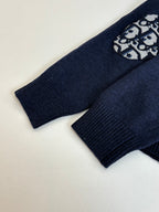 Navy ribbed knit sleeve cuffs with small logo graphic patch