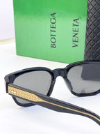 Bottega Veneta sunglasses with dark frame and gold patterned bridge