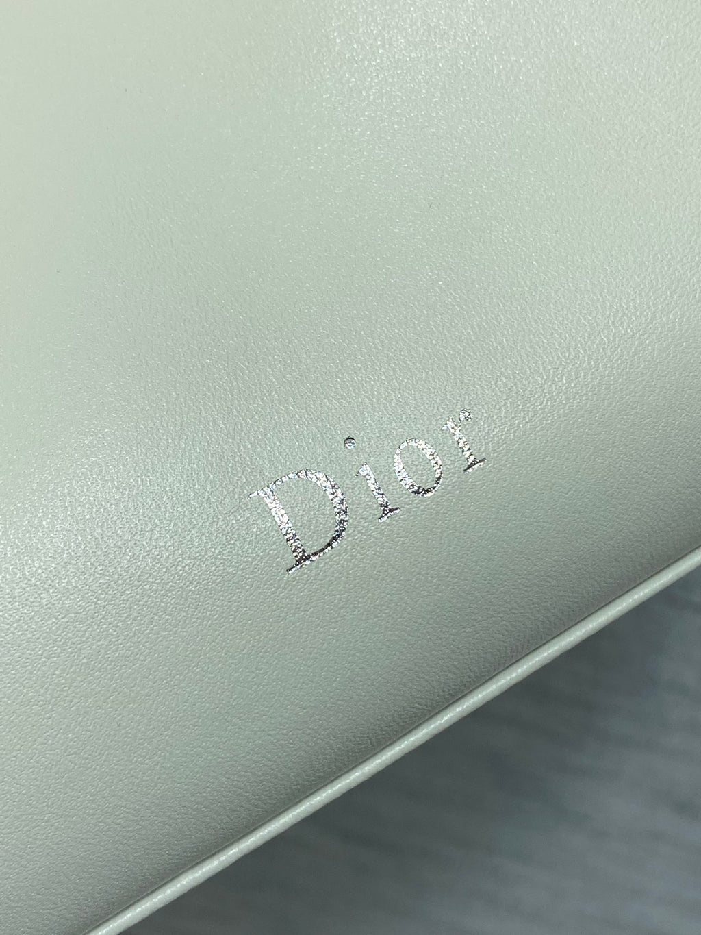 Dior logo embossing on light ivory leather bag