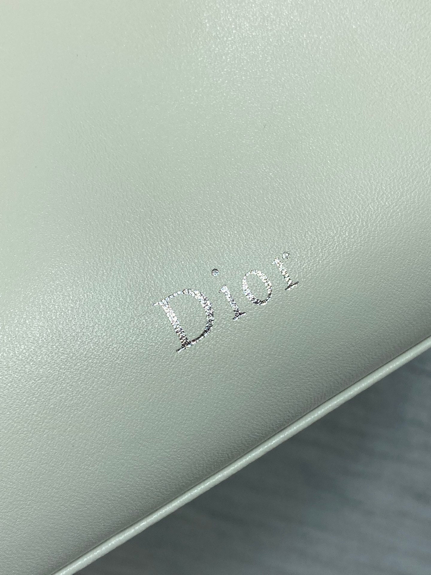 Dior logo embossing on light ivory leather bag
