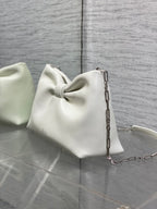 Ivory leather Dior handbag with bow front, chain strap, and back panel