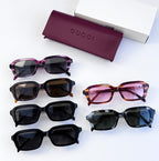Assorted Gucci sunglasses set: black, tortoiseshell, purple, and pink frames with dark lenses.