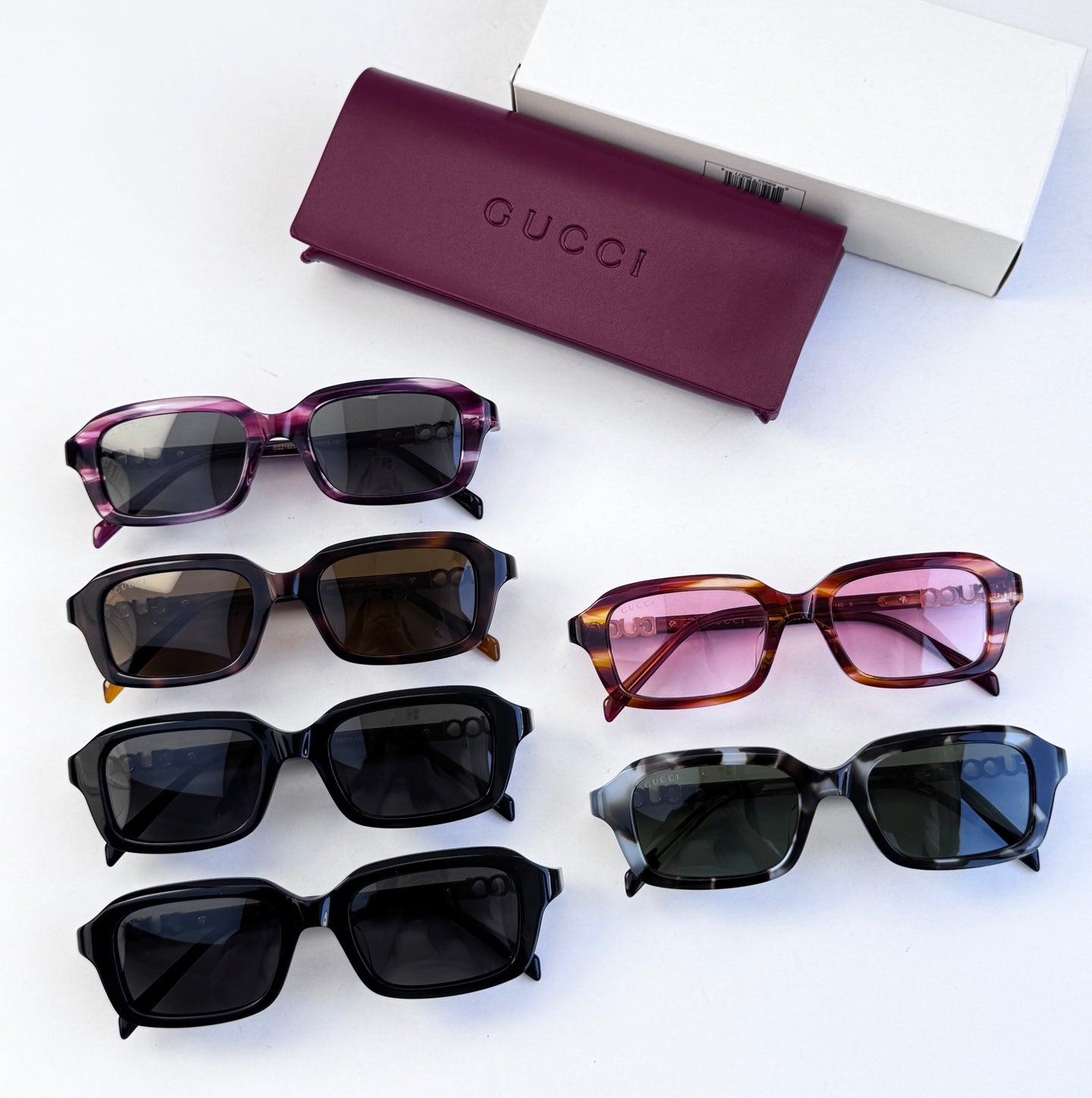Assorted Gucci sunglasses set: black, tortoiseshell, purple, and pink frames with dark lenses.