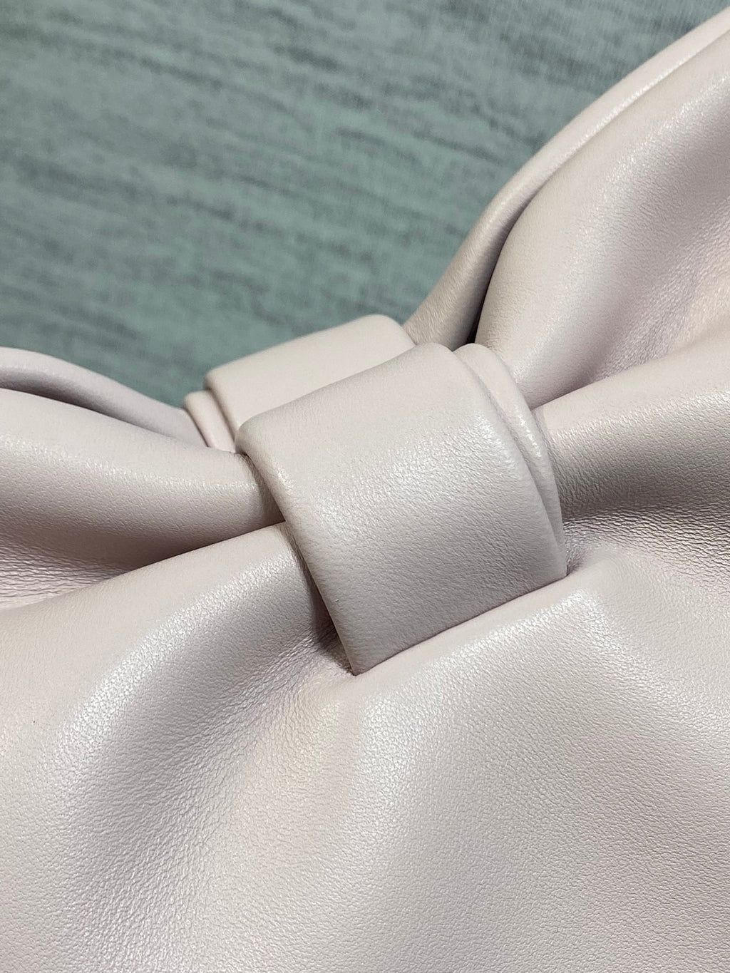 Light pink leather bow detail with matching strap hardware