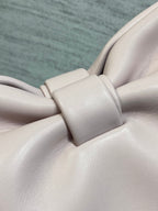 Light pink leather bow detail with matching strap hardware