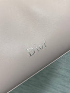 Light pink Dior logo emboss on leather bag side panel